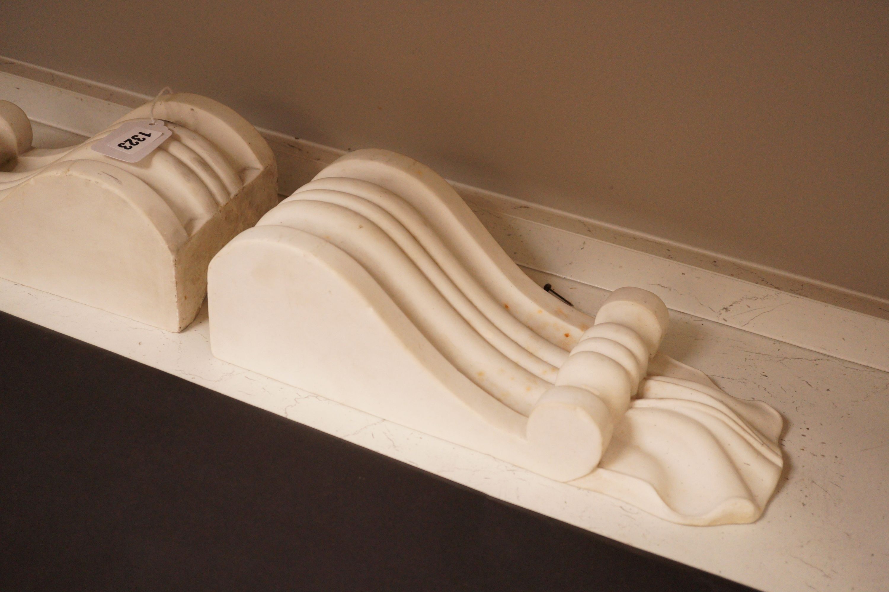A pair of carved white marble scrolling corbels, 38x14cm